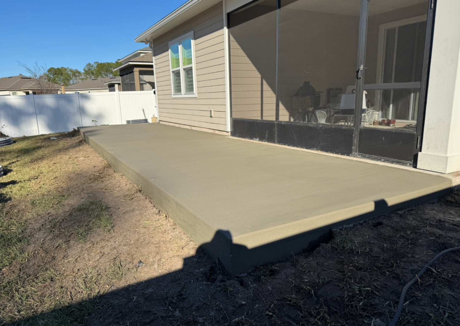 freshly poured backyard patio with tooled edges and clean control joints behind a Columbus home