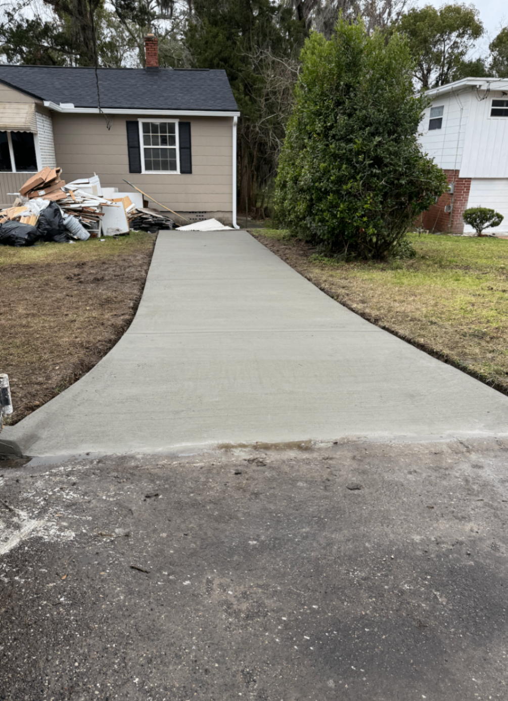 worker applying a polymer overlay to a salt-scaled Columbus driveway