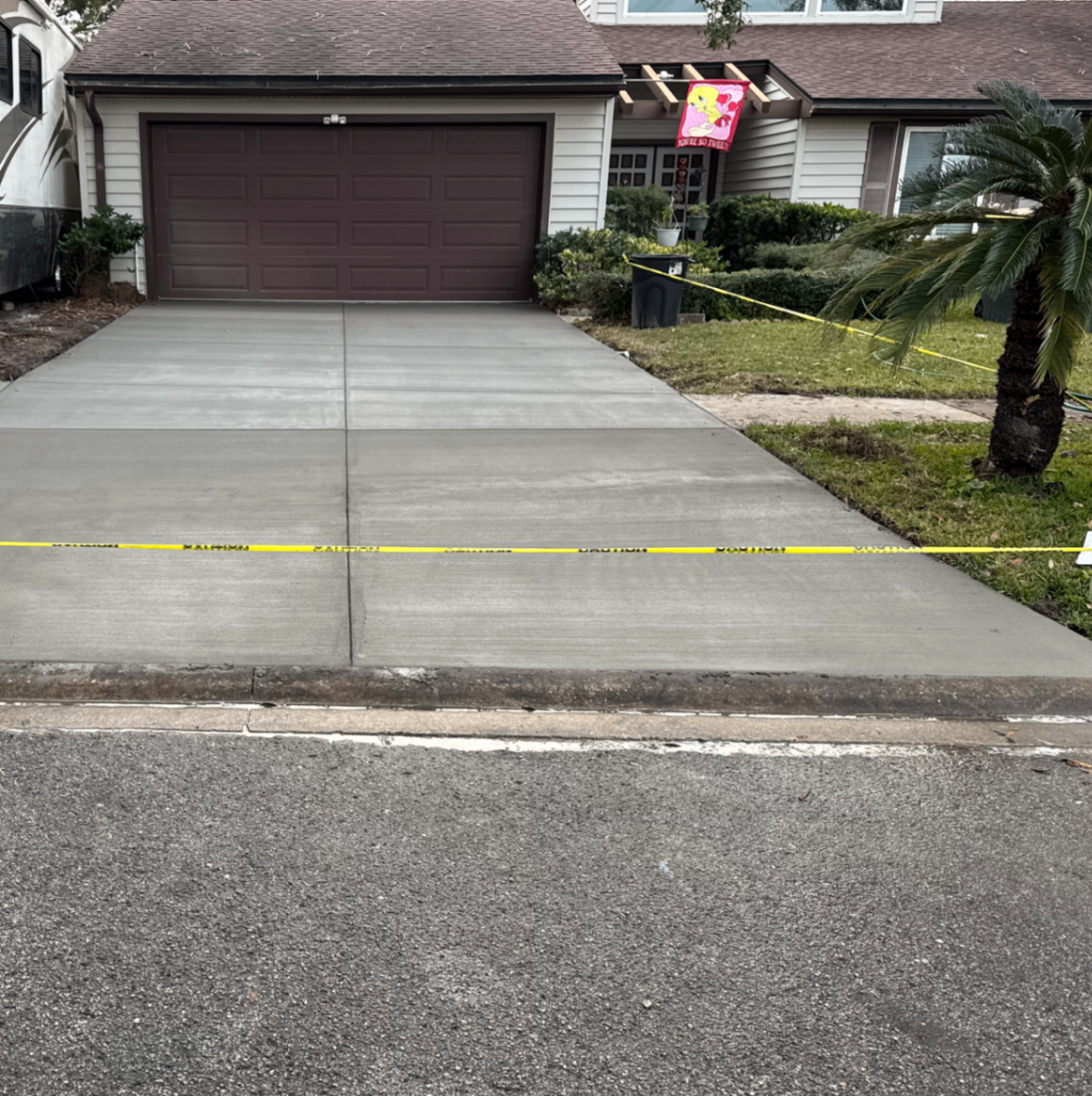 estimator measuring a Columbus driveway with a wheel and clipboard